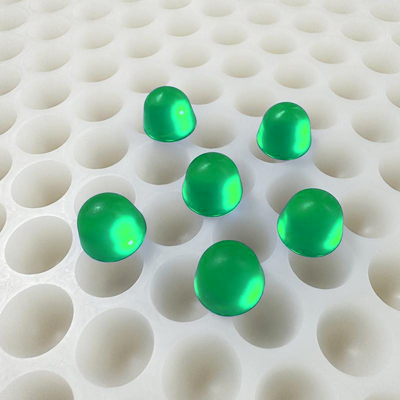 3mL round dome gummy mold with 168 cavities and six emerald green gummies