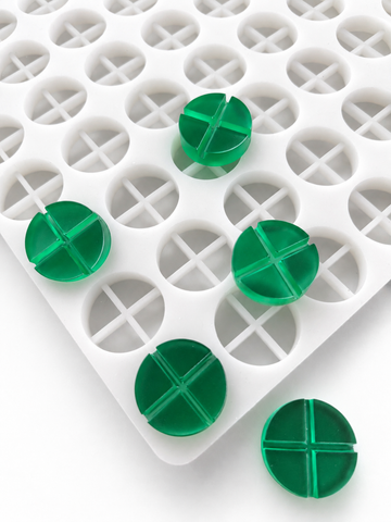 7mL 4-piece disc breaker gummy mold with 70 round segmented cavities and emerald green gummies